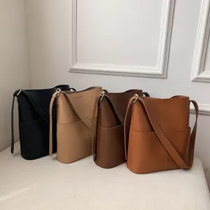 Detail view of stylish minimalist bucket bag, large capacity crossbody shoulder bag in four colors.