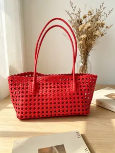 Detailed view of the stylish red woven tote bag, showcasing premium leather texture and grid.
