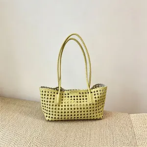 Yellow woven shoulder tote bag for women, large capacity casual commuting handbag for daily use.
