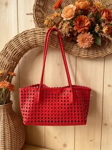 Red woven shoulder tote bag detailed view showcasing stylish lattice design and braided handles.