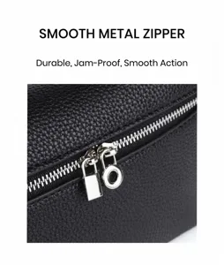 Mini lunch box bag detail view, black textured leather handbag with smooth metal zipper.