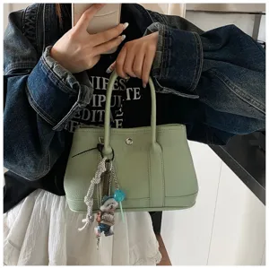 Casual PU leather handbag with top handles and chic charms, versatile everyday mini bag.