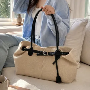 Casual retro large capacity tote bag detail, featuring black leather handles and stylish buckle.