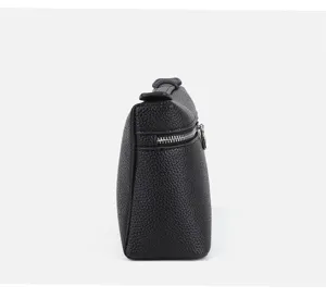 Side detail view of a black mini lunch box crossbody bag, showing textured pu leather structure.