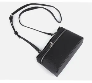 Detail view of a black mini leather bento box bag, stylish crossbody handbag with zipper.