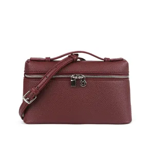 Burgundy mini box bag detailed view featuring structured leather texture and metal hardware.