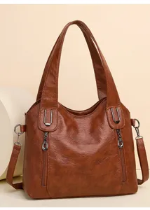Close-up detail of the brown oil wax leather women handbag, showing texture and hardware.
