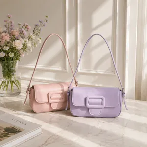 Detailed view of stylish minimalist women's shoulder baguette bags in pink and purple colors.