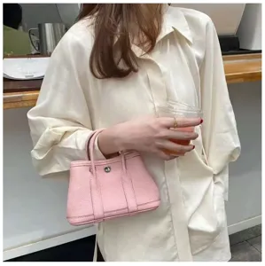 Chic pink leather bucket handbag, stylish casual shoulder tote for daily commute use.