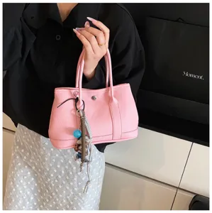 Minimalist pink leather handbag, stylish daily shoulder bag with cute charm pendant.