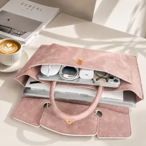 Detailed view of the pink leather laptop handbag with multi-compartment storage for office.