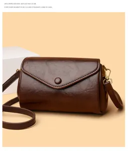 Detailed view of retro brown leather shoulder bag, elegant crossbody design with metal hardware.