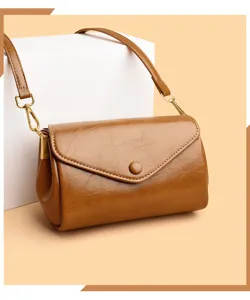 Detailed view of women's vintage brown leather shoulder crossbody bag with gold hardware.