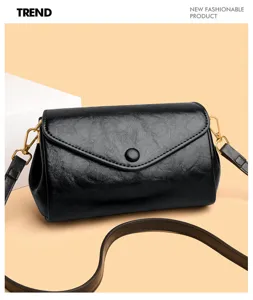 Classic minimalist black leather shoulder bag with chic gold hardware and flap design.