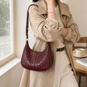 Detailed shot of the retro woven leather shoulder bag showcasing texture and strap metal hardware.
