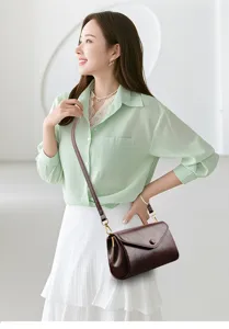 Detail view showing the elegant dark brown leather crossbody shoulder bag worn by the model.