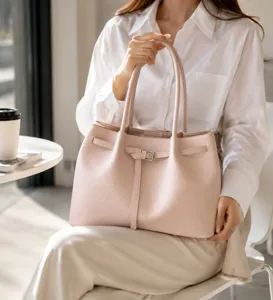 Elegant pink commuter tote bag for women, stylish shoulder bag with buckle detail, daily use.