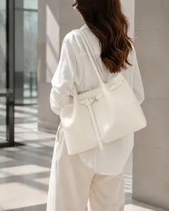 Minimalist shoulder tote bag detail shot, featuring elegant buckle and premium leather finish.