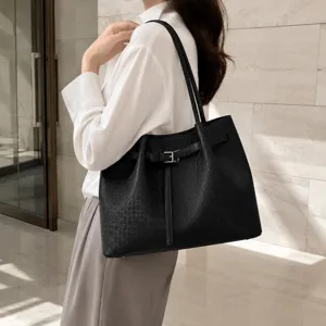 Black woven leather shoulder tote bag for women, stylish commuting handbag with belt.