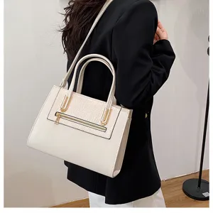 Detail view of vintage cream shoulder bag featuring crocodile texture and metal zipper.
