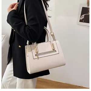 Stylish white commuter shoulder bag with structured design, dual top handles and gold hardware.