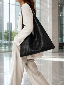 Large black woven leather shoulder bag detail, stylish hobo tote for women commuting.