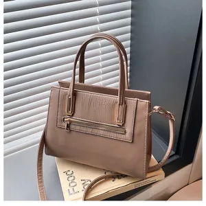 Detail shot of the khaki commuter handbag showcasing front crocodile texture and metal zipper.