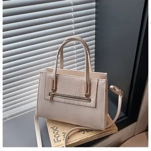 Elegant beige PU leather handbag detail, stylish top handle cross body bag with chic design.