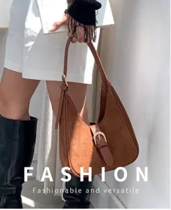 Brown suede hobo shoulder bag for women, stylish underarm crescent bag with metal buckle.