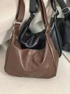 Detail view of soft leather slouchy shoulder bag, large capacity design, vintage brown tote style.