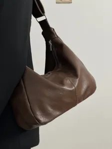 Detail view of women retro soft leather slouchy shoulder bag large capacity brown tote.