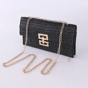 Black woven straw shoulder bag with gold chain strap and chic geometric turn lock