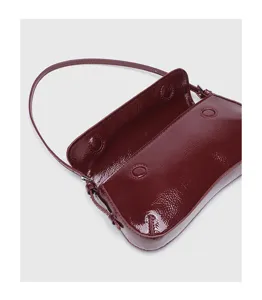 Glossy burgundy baguette shoulder bag for women, minimalist chic patent leather underarm purse.