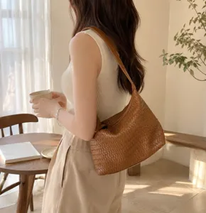 Brown woven leather shoulder bag detail, stylish hobo design for casual daily commute.