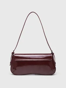 Chic red patent leather baguette shoulder bag with flap and curved bottom for stylish daily wear.
