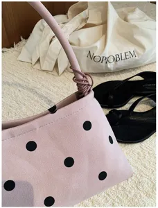 Korean style pink polka dot underarm bag, simple casual single shoulder handbag detail shot.