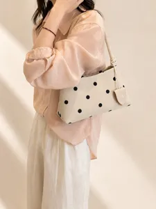 Chic polka dot underarm shoulder bag for women, casual soft handbag with chic knot detail.