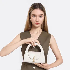 Chic minimalist semi-circular handbag with elegant metal lock, perfect for daily commuting.