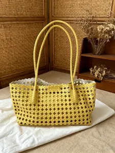 Yellow woven leather tote bag for women, stylish large capacity commuter shoulder handbag.