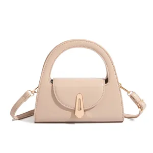 Elegant beige women handbag with top handle and metal lock chic crossbody fashion design.
