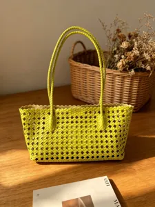 Lime green woven leather tote bag detailed view showcasing intricate intrecciato grid pattern.