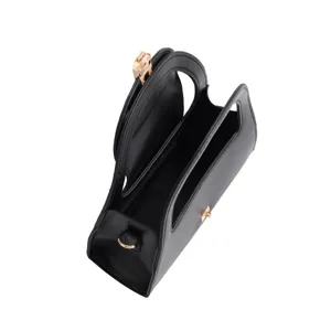 Close-up detail of the black women handbag featuring metal lock and dual compartments.