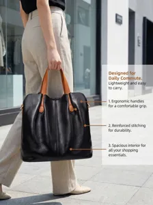 Stylish black leather tote bag with brown handles, spacious interior for daily commute.