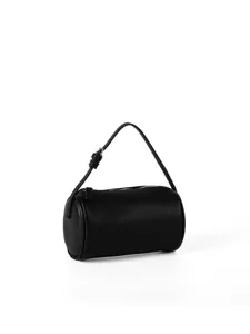 Detailed view of the black cylindrical handbag showing lychee texture and fine zipper.