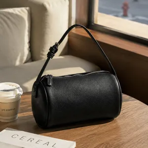 Minimalist black leather barrel bag, detailed texture view, chic daily shoulder strap.