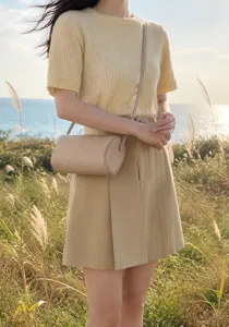 Detailed view of women minimalist litchi grain cylindrical crossbody bag, elegant style.