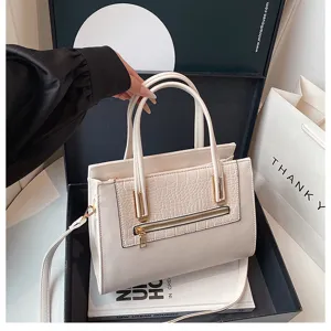 Stylish minimalist white shoulder handbag with crocodile embossed panel and top handles for women.