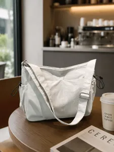 Casual waterproof nylon crossbody bag for women, large capacity commuter shoulder bag.