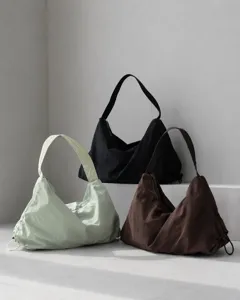 Detailed view of minimalist nylon hobo shoulder bags in multiple colors for daily use.