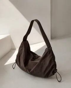 Minimalist dark brown nylon hobo shoulder bag detail view, casual underarm tote style.
